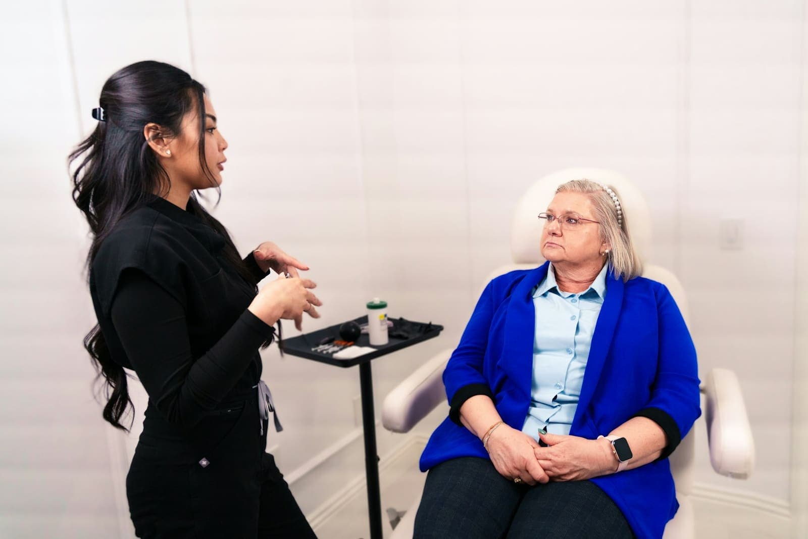 Provider talking through a treatment plan with a seated client