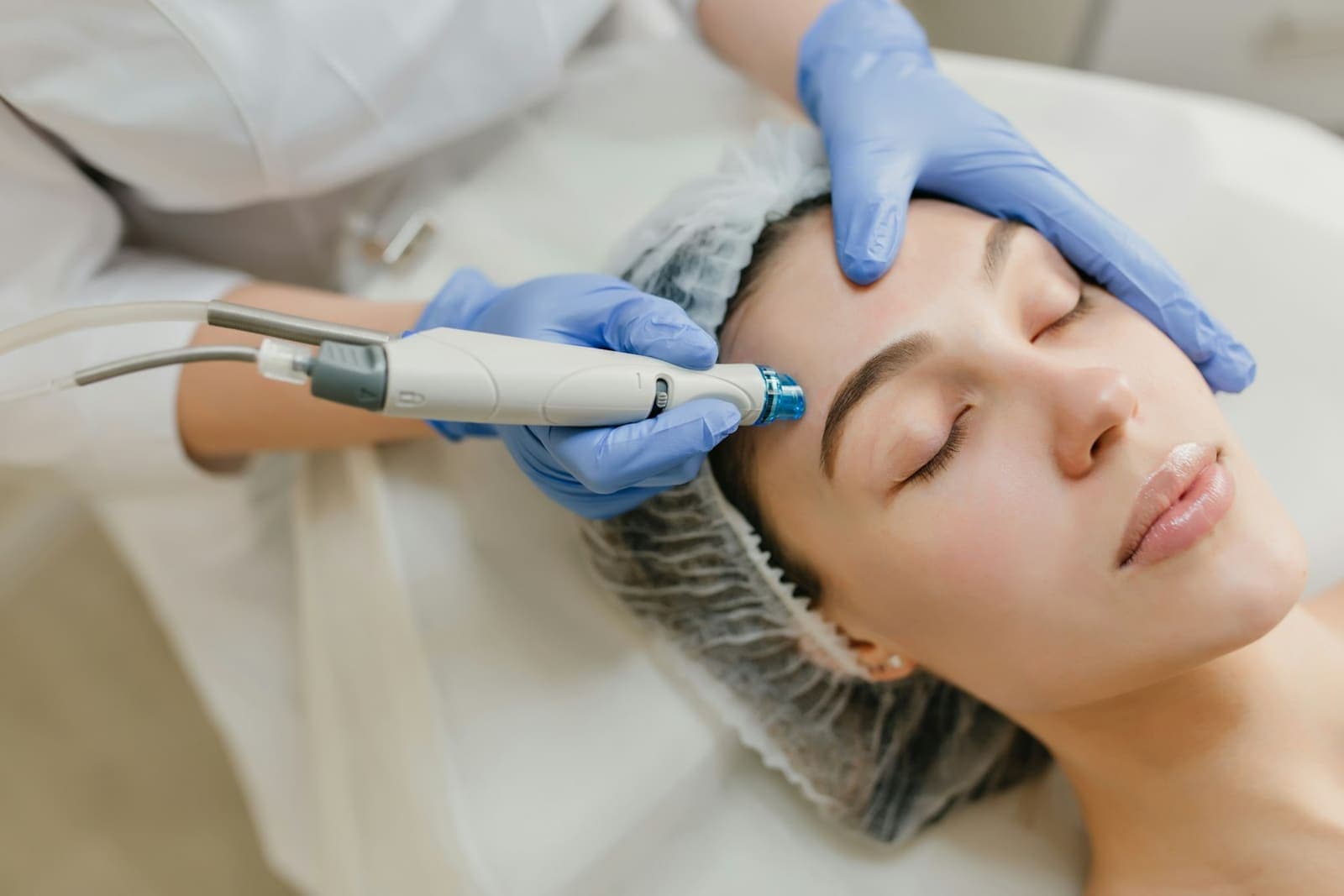 Provider using a facial treatment device on a client