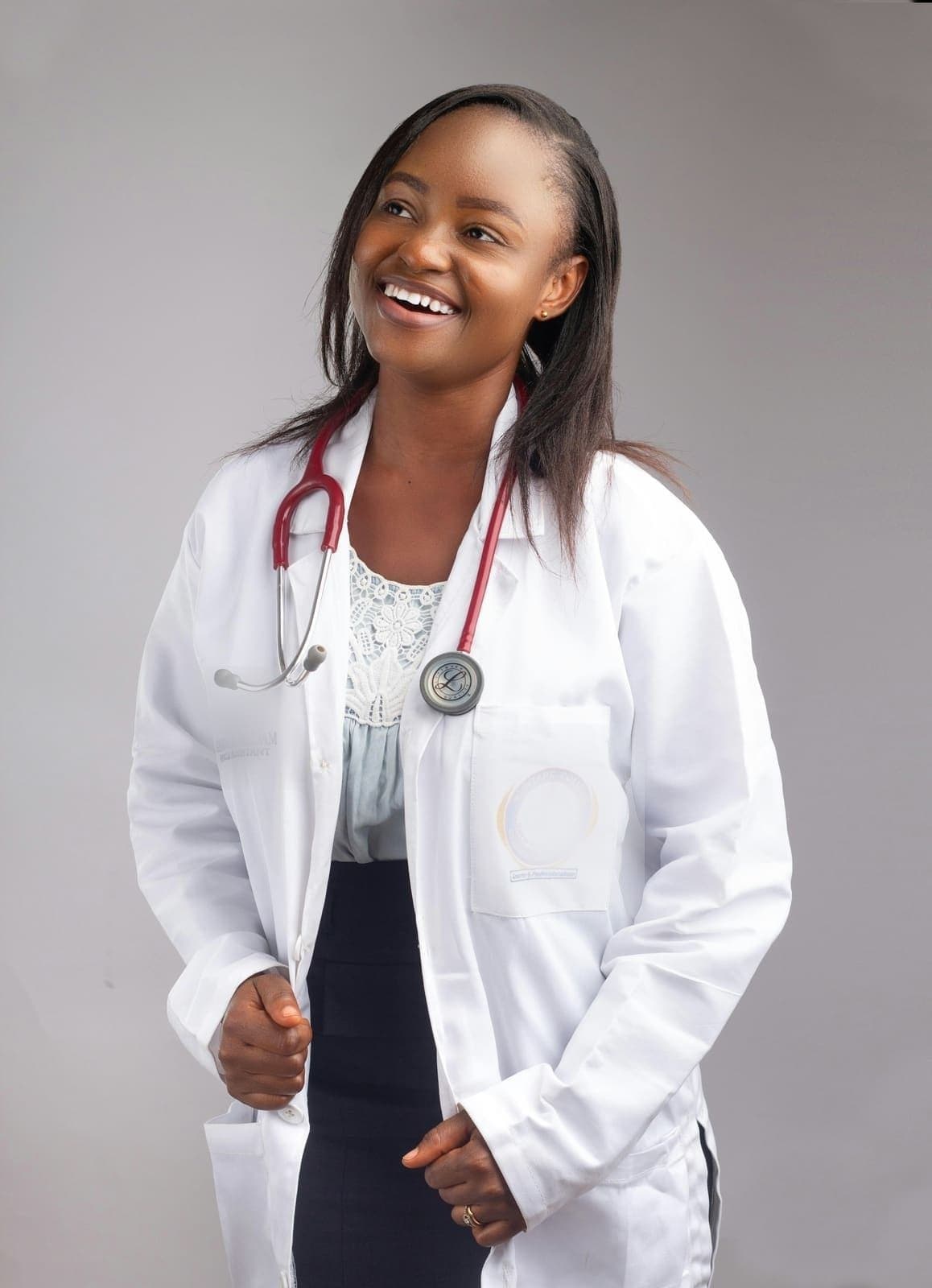 Provider in a white coat with a stethoscope, laughing