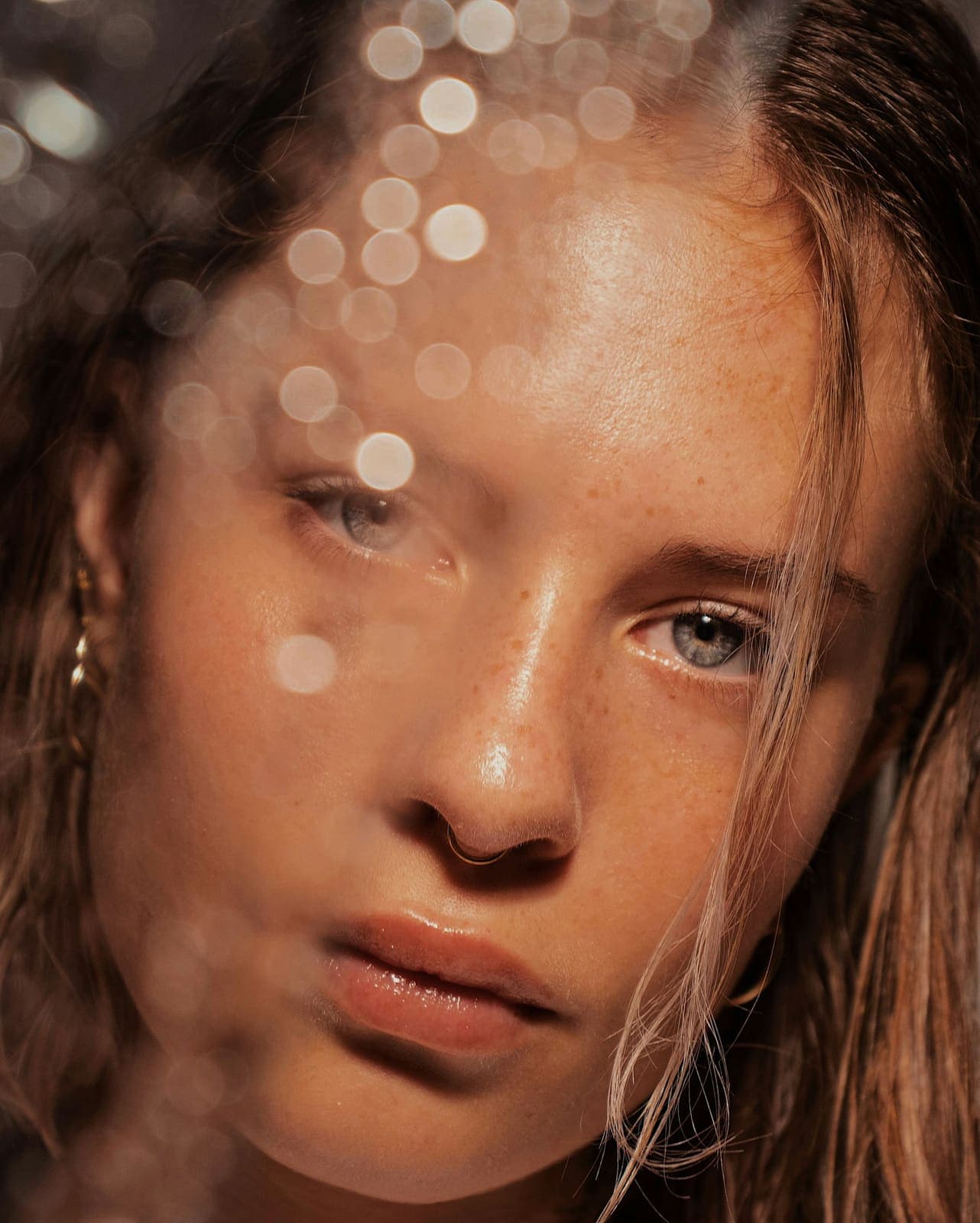 Close portrait of a woman with freckled, glowing skin